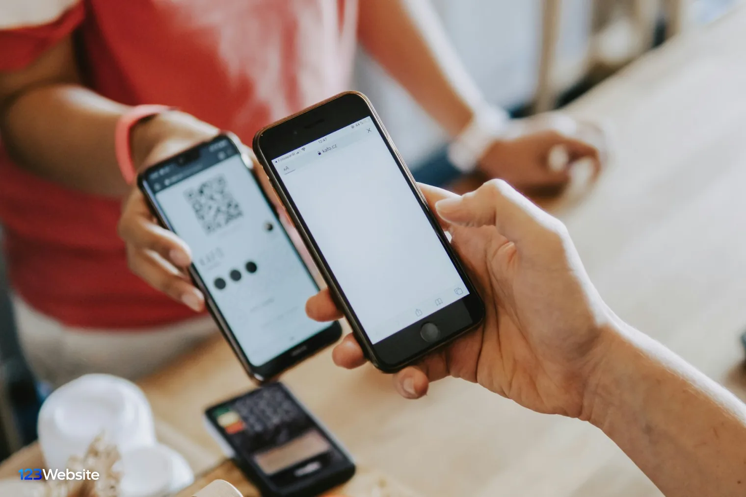 Customer scanning a QR code with a phone to pay a Shopify order by bank transfer